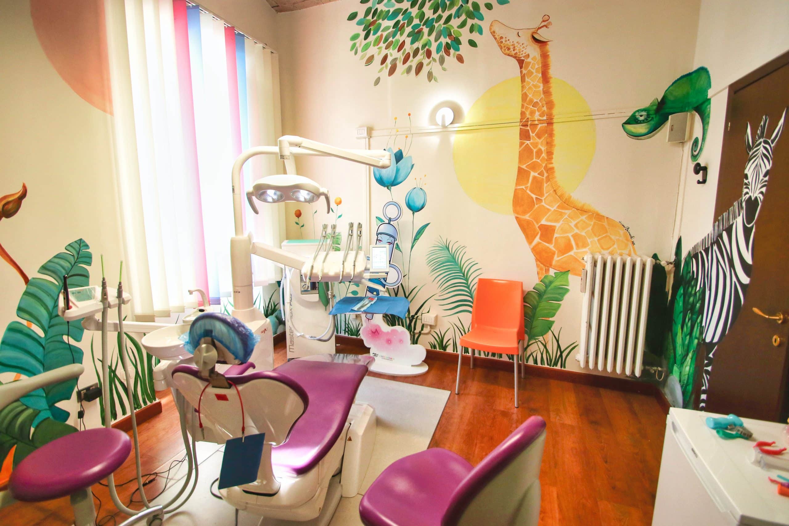 Studio dentistico colorato con murales di animali.